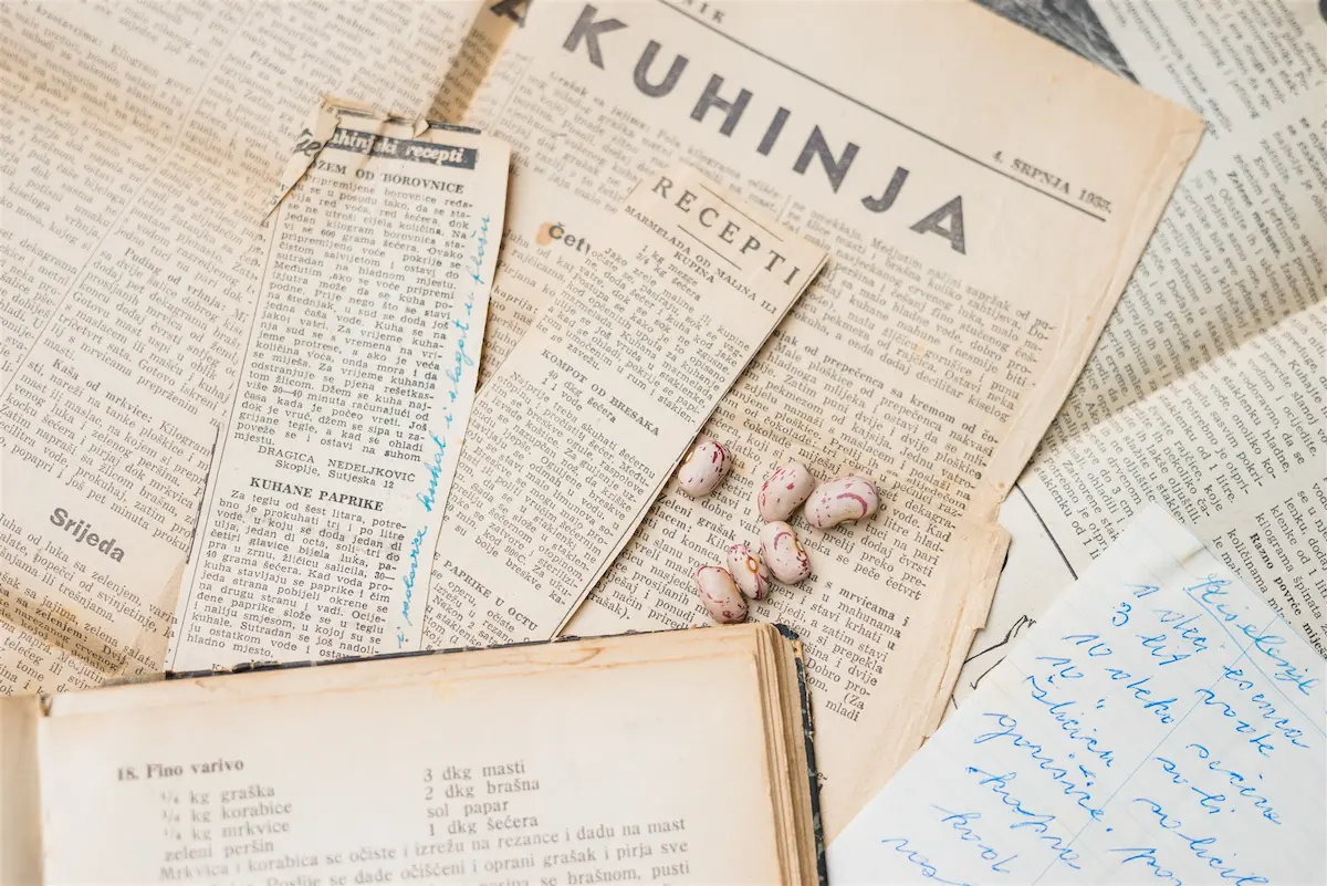 Old recipe clippings, a cookbook and handwritten notes — one category gathered and reviewed as a whole