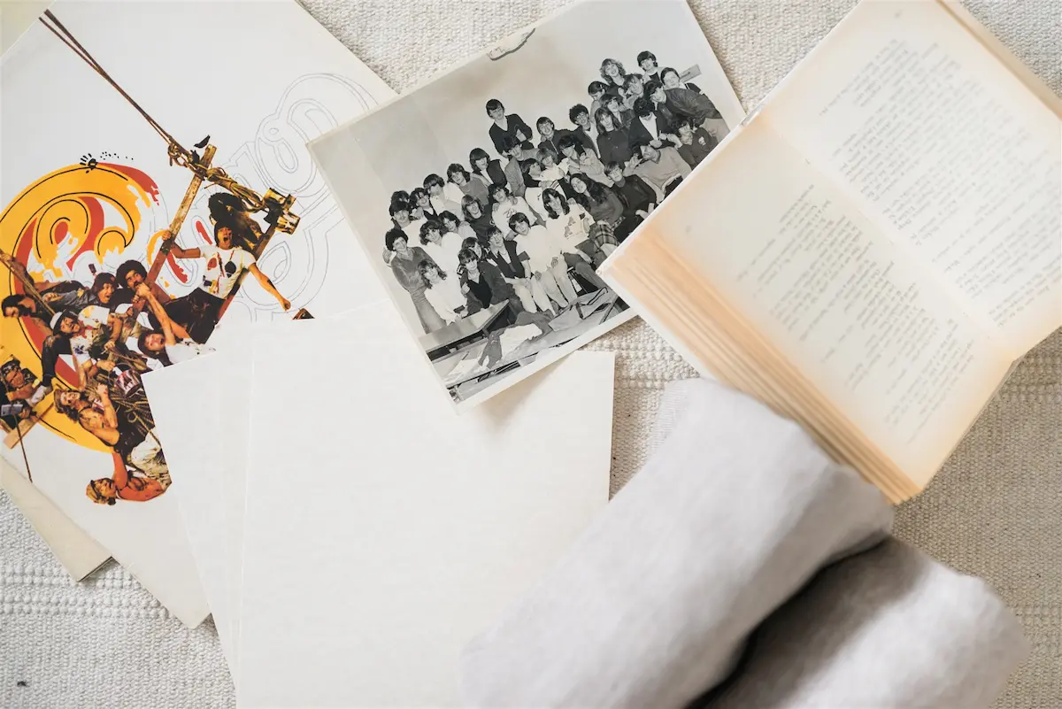 Photographs, books, papers and textiles gathered together — decluttering across several related categories