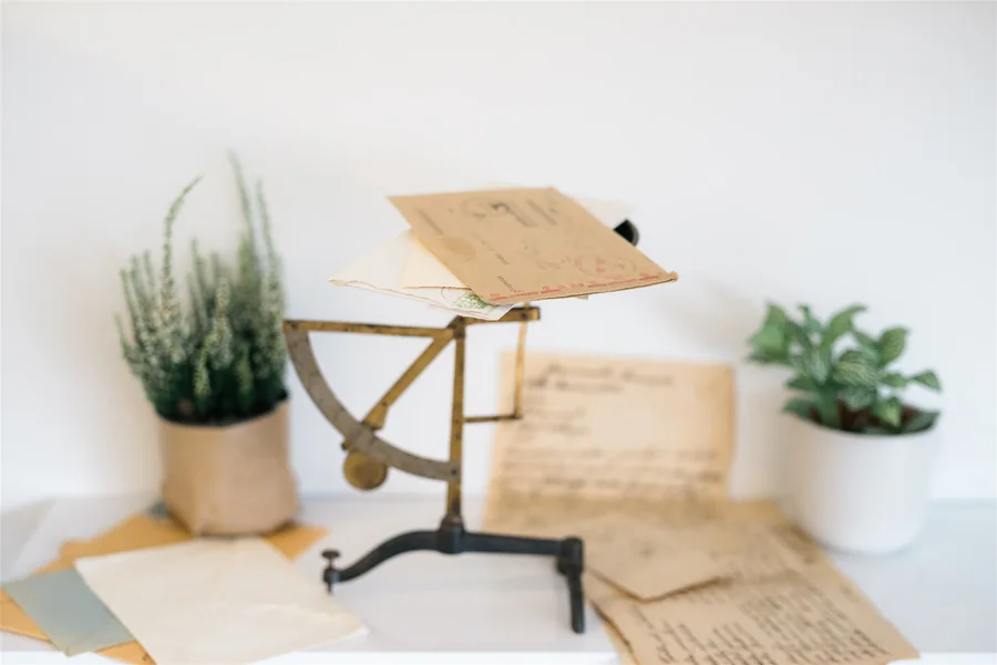 Old letters on a brass stand — Root of Joy client testimonials