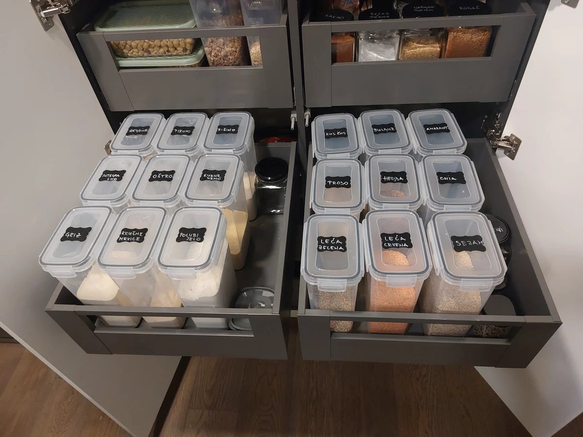 The same drawers after organizing — food in labelled clear containers