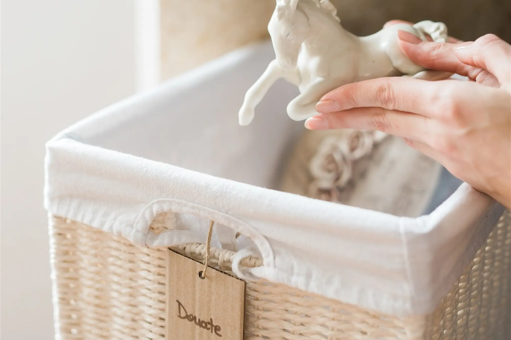 Hands placing an ornament into a basket labelled for donation — donation pickup and rehoming in Zagreb