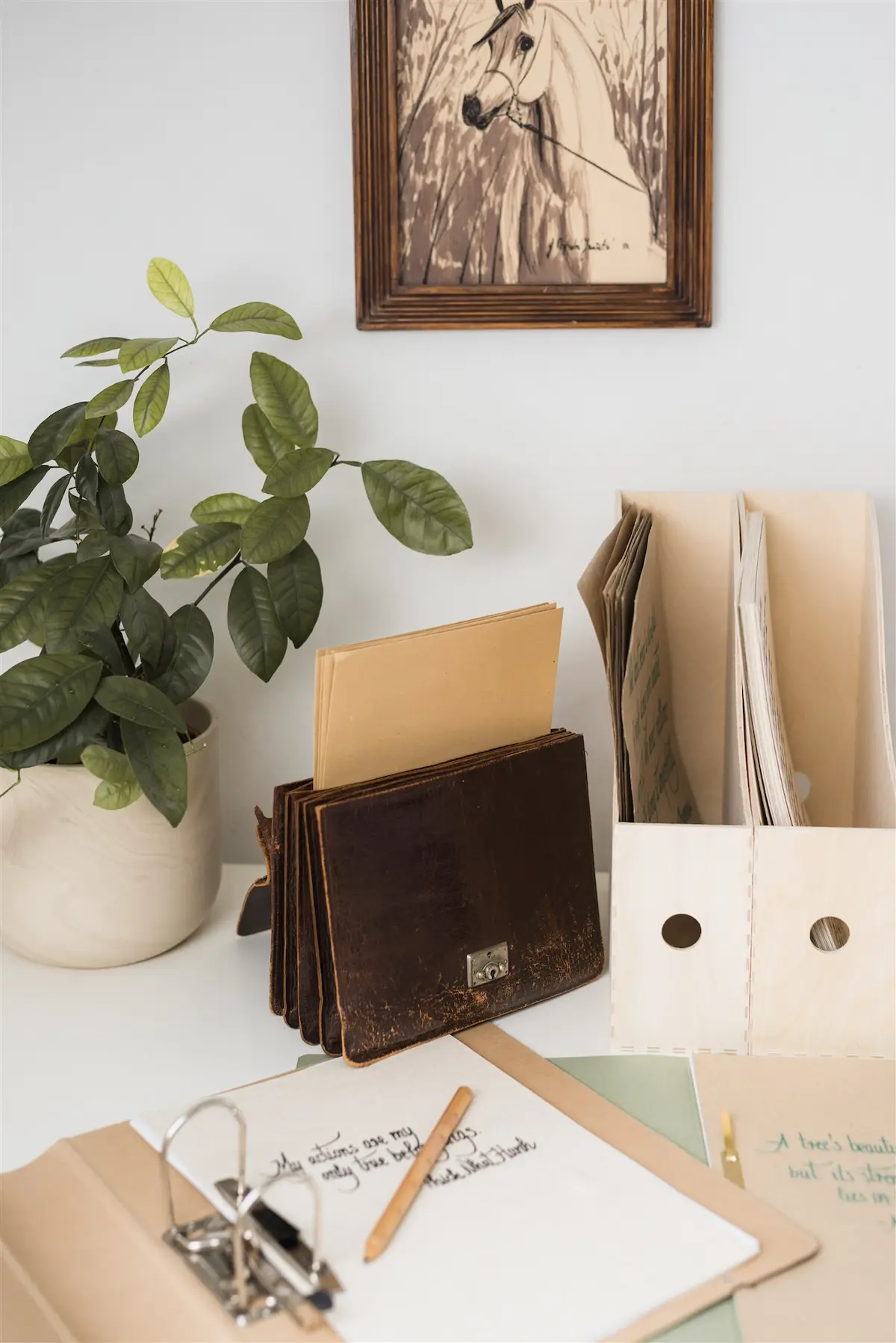 Organized desk with wooden magazine files, a ring binder and sorted documents — setting up a workspace after a relocation in Zagreb