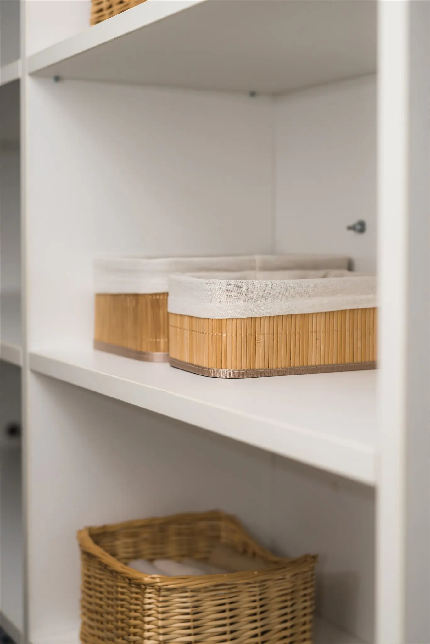 Organized white shelving with storage baskets after home renovation — functional storage solutions in Zagreb