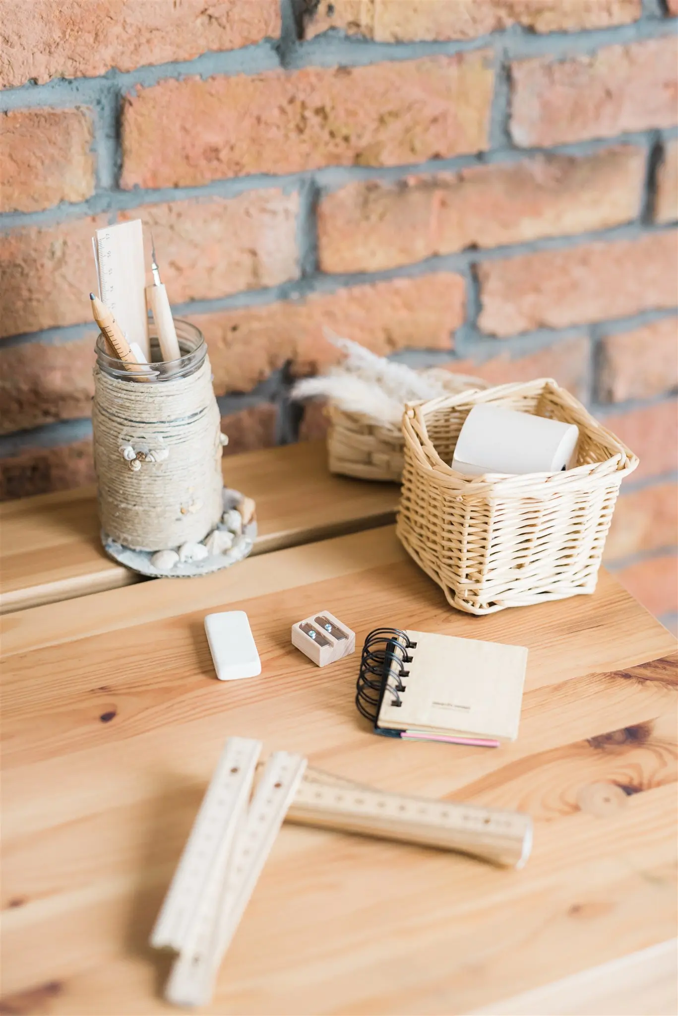 Desk supplies, a notebook and a wicker basket on a wooden desk — home office decluttering in Zagreb