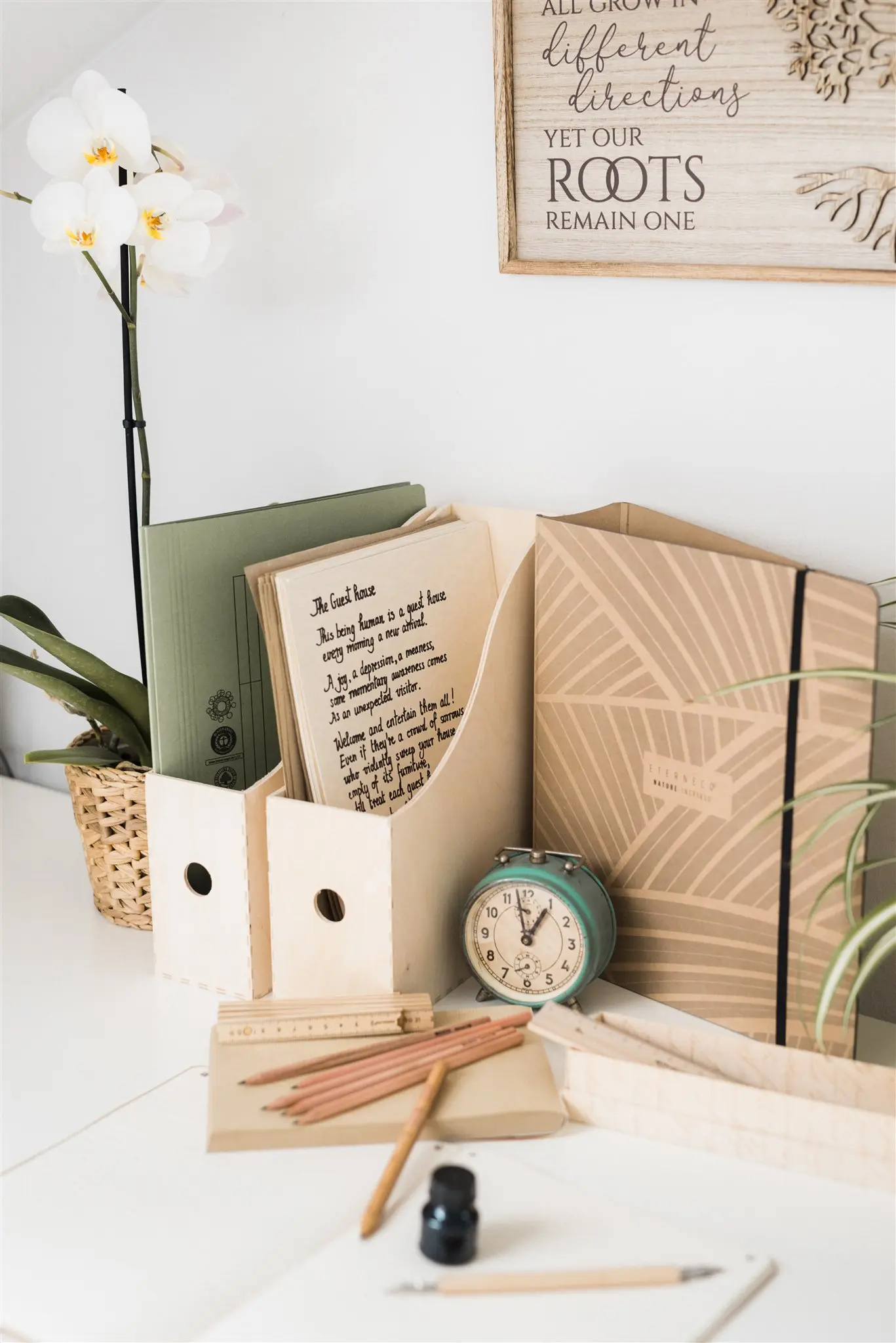 Desk with document holders, an orchid and a clock — an organized filing system for a workspace in Zagreb