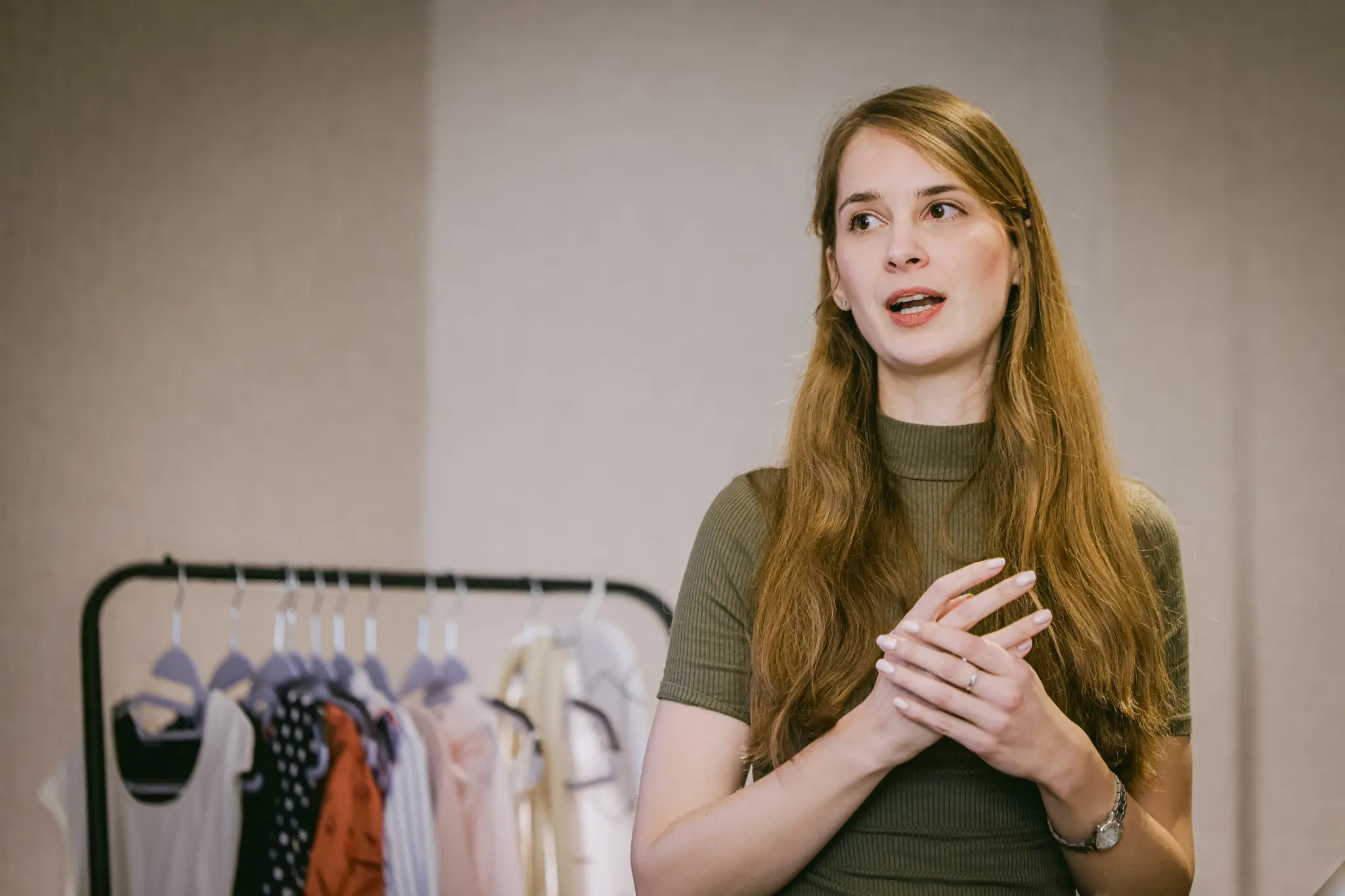 Petra Pupić speaking at a KonMari® workshop, a clothing rail behind her — workshops on the method in Zagreb