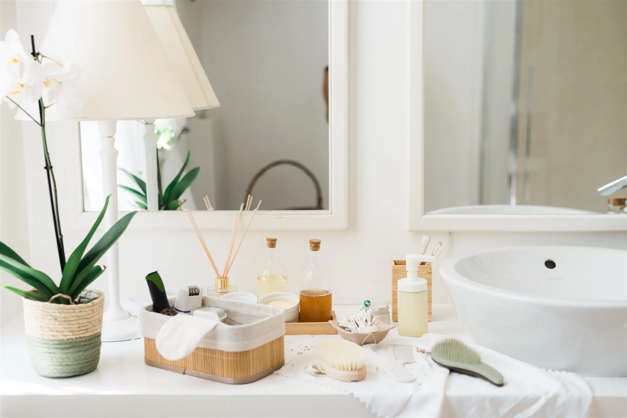 Bathroom shelf with bamboo brushes, refillable bottles and an orchid — zero waste consultation for the bathroom in Zagreb