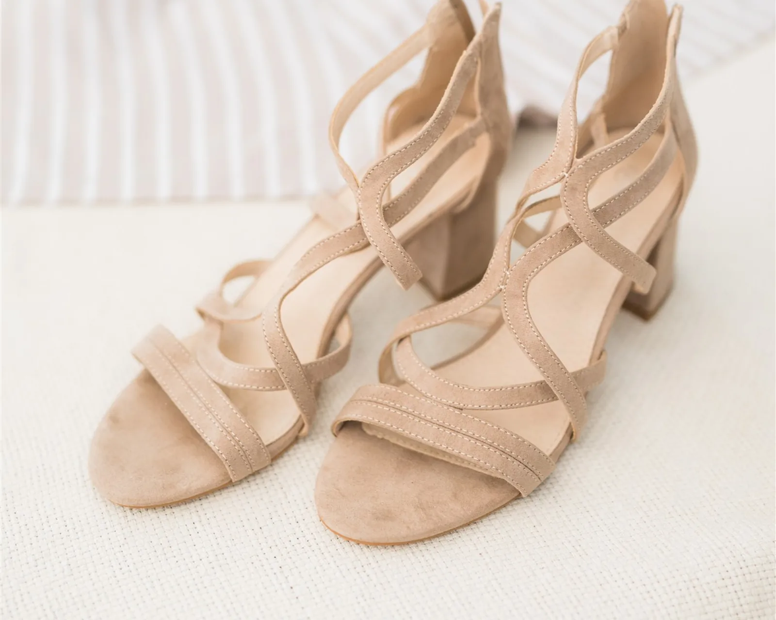 Beige strappy sandals on a light surface — organizing shoes the KonMari® way