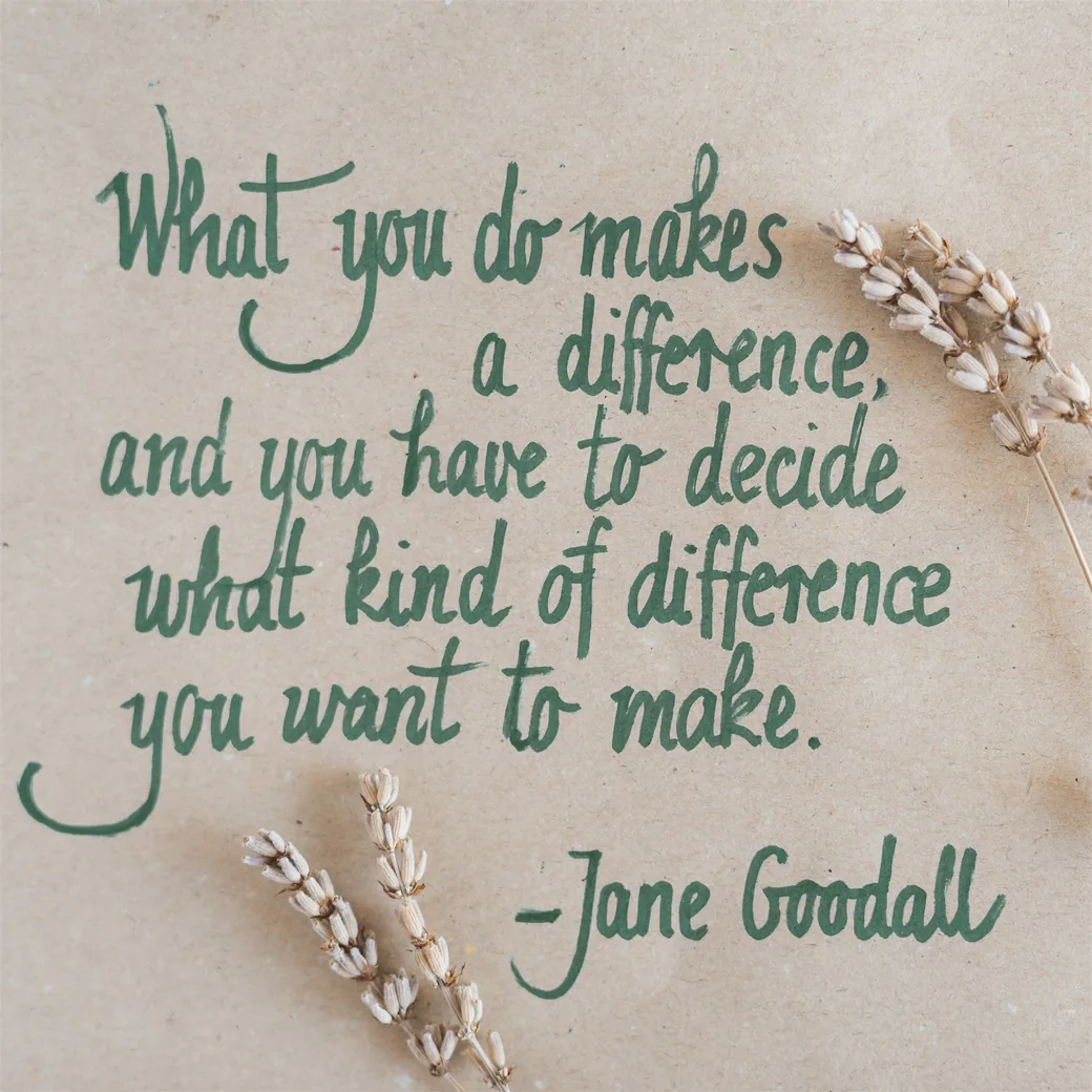 A handwritten Jane Goodall quote in green ink on recycled paper, with dried lavender