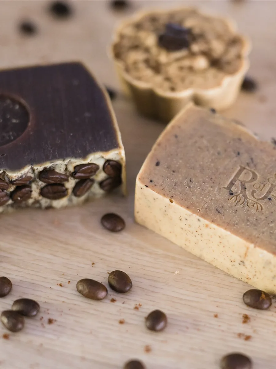 Coffee and cocoa soaps stamped with the Root of Joy mark, with coffee beans
